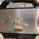 The waffle maker once it’s out of the box. The lights tell you if it’s powered on or ready to cook.